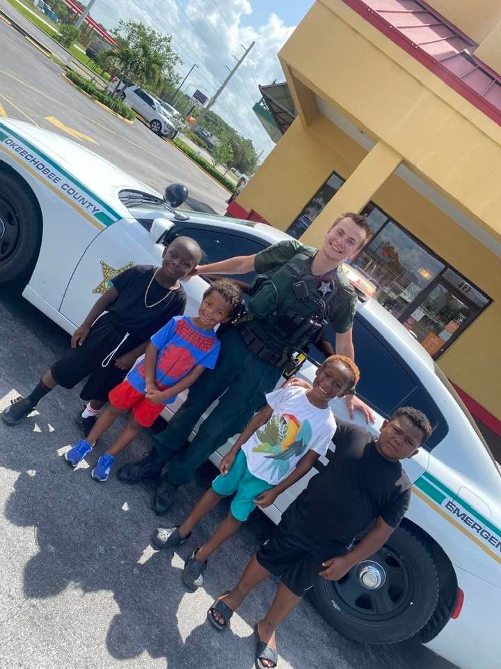 OCSO deputy Skylar Casian takes time out of his busy day to meet some young boys and show them his squad car.